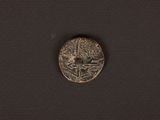 a close up of a coin on a black surface