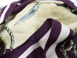 a purple and white scarf with a knife on it