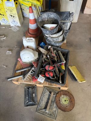 une caisse remplie d'outils posée par terre dans un garage