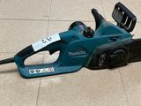 a blue corded saw on the floor with a tag attached to it