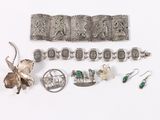 several pieces of silver jewelry including a bracelet, broochle, and earrings