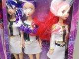 two dolls in a package with a pink hair and white dress