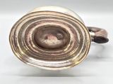 an image of a silver vase on a white surface