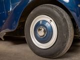 a close up of a blue car parked in a garage