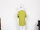 mannequin in front of a white wall with a green shirt on it