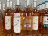 several bottles of wine are lined up on a counter