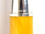 a yellow and silver object on a white surface