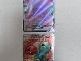 three different pokemon cards sitting on top of a table