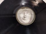 a black vinyl record with a picture of a woman ' s face on it