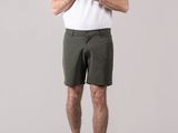 man in white shirt and khaki shorts posing for a picture