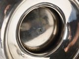 a close up of a metal bowl with a small hole in it