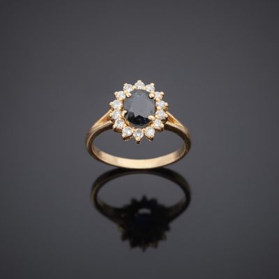 a gold ring with a black diamond and white diamonds