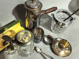 a lot of silver and glass items on the table