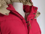 the back view of a woman ' s red jacket with a hood