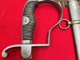 a knife and a lighter on a red cloth