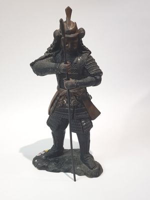 a statue of a man in armor holding a sword