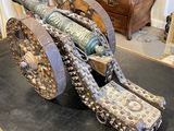a large metal cannon sitting on top of a table