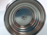 a close up of a silver cup on a table