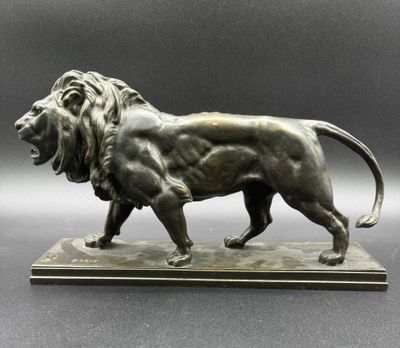 an image of a bronze statue of a lion on a marble base
