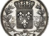 a silver coin with a crown on top of it