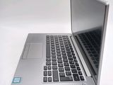 a silver laptop computer sitting on top of a white table