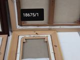 two wooden frames that are on display on a table