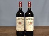 two bottles of wine sitting on a wooden table