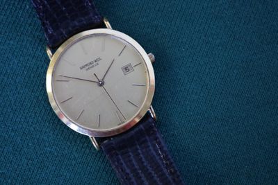 a watch that is sitting on a blue cloth