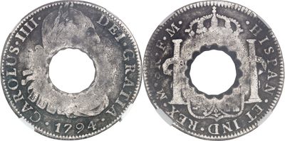 a close up of a coin with a hole in the middle of it
