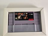 an old nintendo game in a white box on a white surface