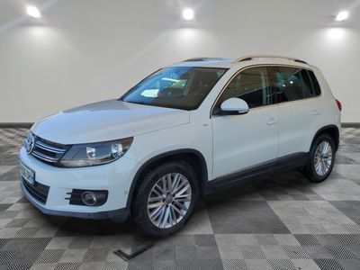 the white volkswagen tigua is parked in a large room