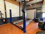 an image of a garage with a lot of tires on the floor