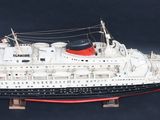 a model of a large boat on a black surface