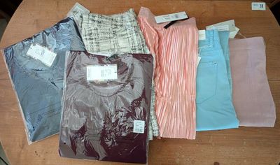 a lot of shirts that are on a table