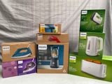 several boxes of household appliances sitting on a table next to each other