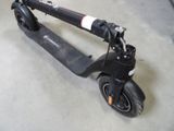 a scooter that is sitting on the floor in the garage