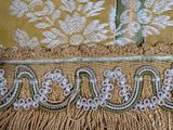 a close up of a table cloth with fringes on it