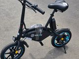 an image of a black and blue bicycle parked in a parking lot