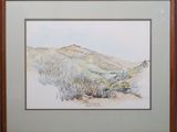 framed watercolor painting of a desert landscape in a wood frame
