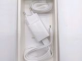 a white box with a charger and a cable in it
