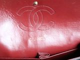a close up of a red purse with a chain on it
