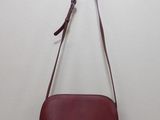 a red handbag hanging on a wall in a room