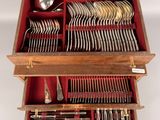a wooden box filled with silverware and spoons