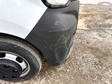 a close up of a car ' s front bumper with a black and white stripe