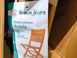 a cardboard box with a chair in it and a bag on top of it