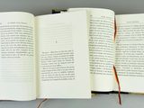 an open book with a pencil on top of it