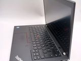 a black laptop with a red button on the keyboard