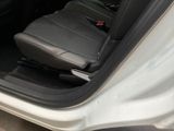 a white car with black leather seats and a black seat belt