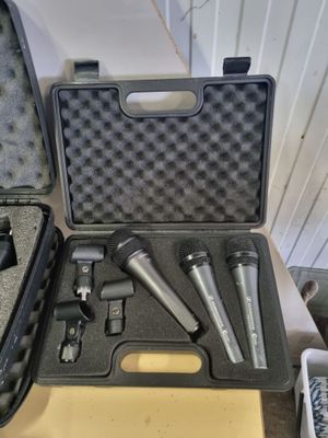 three microphones in a case sitting on a table