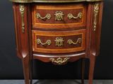 an antique wooden chest of drawers with a marble top